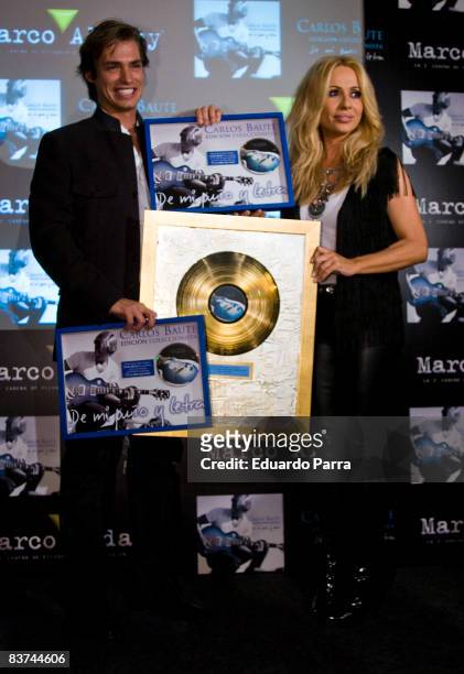 Singer Marta Sanchez gives to Carlos Baute a gold disc for more than 50,000 sales of her album 'De Mi Puno Y Letra' at ME Hotel on November 18, 2008...