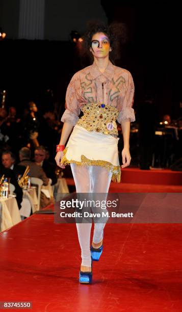 Model walks down the catwalk showcasing Vivienne Westwood's Gold Label Collection during the Chaos Point Gala Dinner in collaboration with the London...