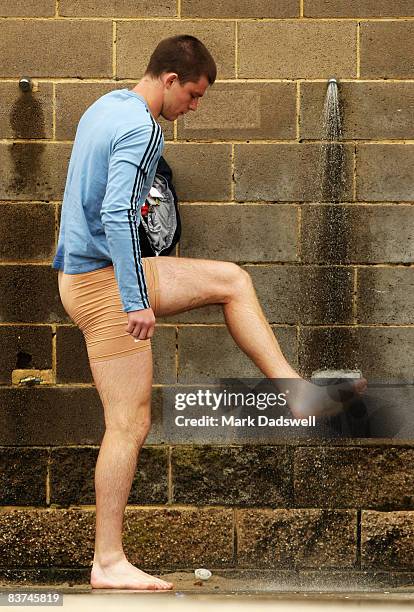 Bryce Gibbs of the Blues washes sand from his feet during a pre-season Carlton Blues AFL recovery session at Port Melbourne Surf Life Saving Club on...