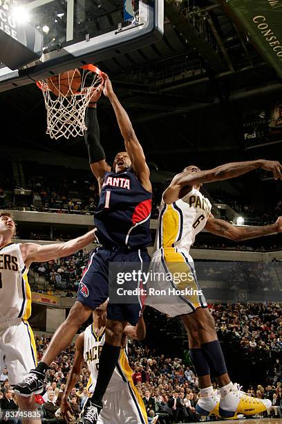Maurice Evans of the Atlanta Hawks dunks over Marquis Daniels of the Indiana Pacers at Conseco Fieldhouse on November 18, 2008 in Indianapolis,...
