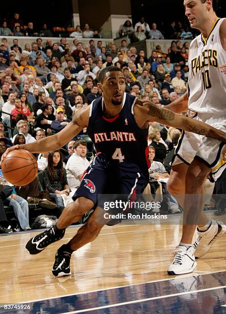 Acie Law of the Atlanta Hawks drives on Jeff Foster of the Indiana Pacers at Conseco Fieldhouse on November 18, 2008 in Indianapolis, Indiana. The...