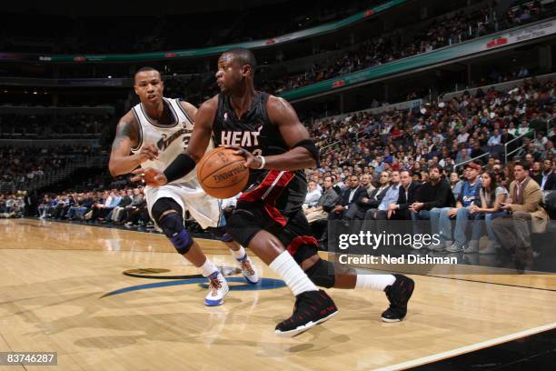 Dwyane Wade of the Miami Heat drives against Caron Butler of the Washington Wizards at the Verizon Center on November 18, 2008 in Washington, DC....