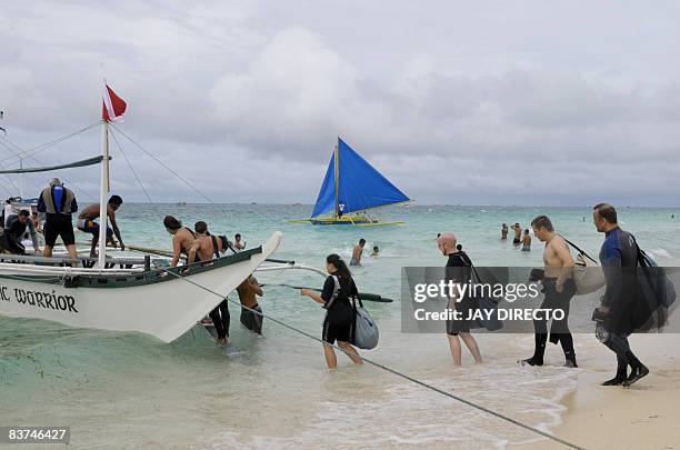 Lifestyle-Philippines-tourism-property,FEATURE" by Cecil Morella SCUBA diving tourists board an outrigger on the fabled beach of Boracay island on...