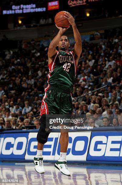 Charlie Bell of the Milwaukee Bucks takes a shot against the Denver Nuggets defends at the Pepsi Center on November 18, 2008 in Denver, Colorado. The...