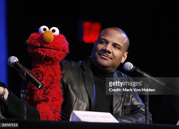 Muppet Elmo and Performer for Elmo, Emmy-winning performer, producer and director, Kevin Clash pose at the "Sesame Street: Made In NY" panel...
