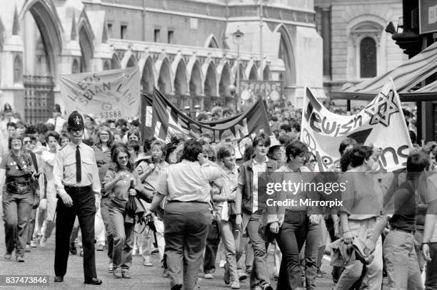 Lesbian and Gay Pride March 1983 through the streets of central London escorted by police. June 1983.