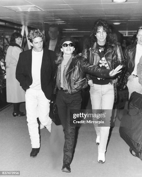 Kylie Minogue with Alice Cooper and Charlie Schlatter arrive at Heathrow Airport.