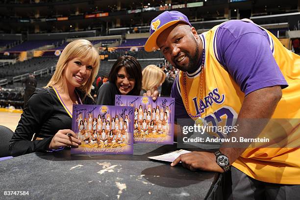 The Los Angeles Laker Girls sign autographs and pose for photos with fans who donated money to the American Red Cross Disaster Relief Fund to assist...