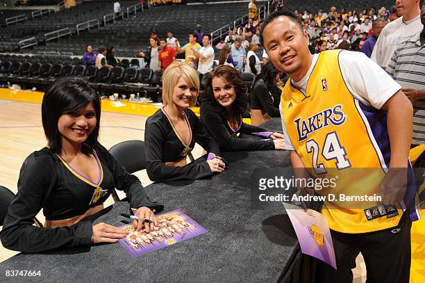 The Los Angeles Laker Girls sign autographs and pose for photos with fans who donated money to the American Red Cross Disaster Relief Fund to assist...