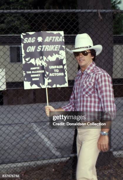 Actor Patrick Duffy holds a SAG and AFTRA Actors On Strike picket sign in circa 1980 in Los Angeles, California.