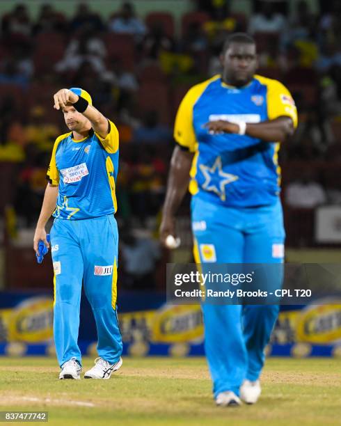 In this handout image provided by CPL T20, Shane Watson sets the field for Rahkeem Cornwall of St Lucia Stars during Match 21 of the 2017 Hero...