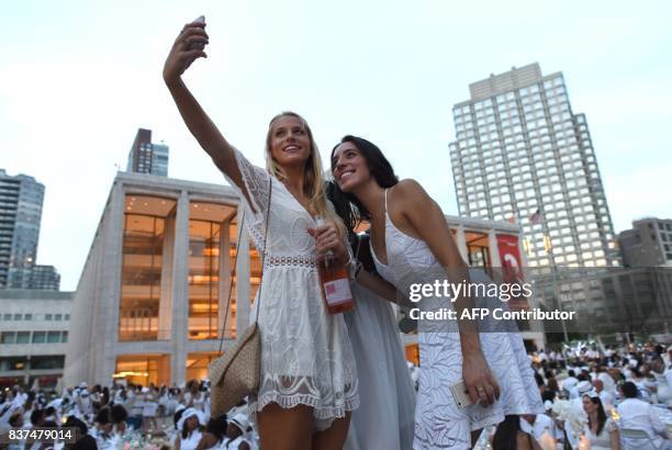 Guests attend the annual New York City Diner en Blanc, August 22, 2017 held this year at the plaza at Lincoln Center. The Diner en Blanc, the worlds...