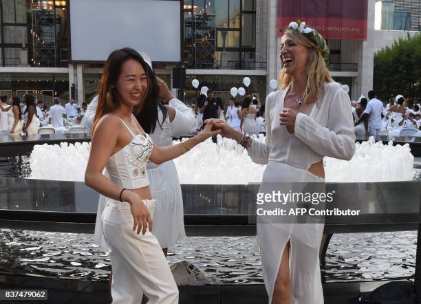 Guests Claire Traugott and Jamie Pabst attend the annual New York City Diner en Blanc, August 22, 2017 held this year at the plaza at Lincoln Center....