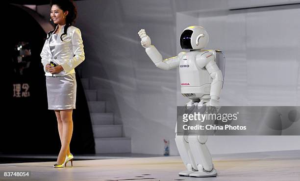 Honda's rumanoid walking robot waves to visitors on the press day of the 6th Guangzhou International Automobile Exhibition, on November 18, 2008 in...