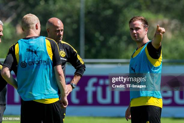 Sebastian Rode of Dortmund , Head coach Peter Bosz of Dortmund and Mario Goetze of Dortmund looks on during a training session as part of the...