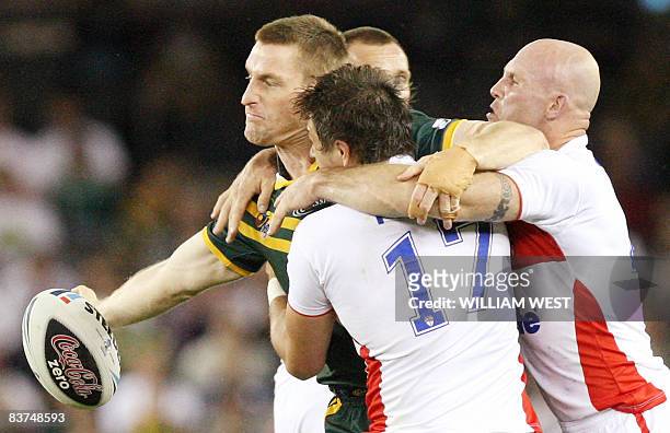 Australian player Brent Tate off-loads a pass as England defenders Jon Wilkin and Keith Senior tackle in their Rugby League World Cup match at the...