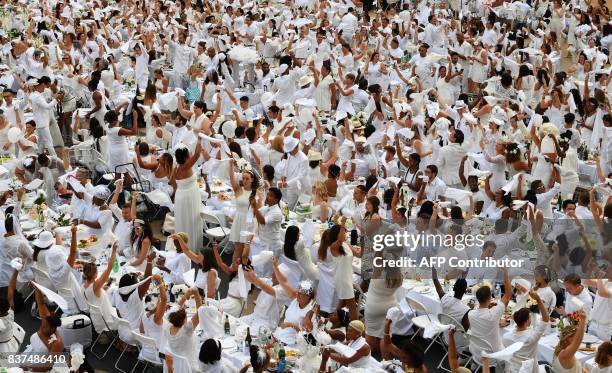 Guests attend the annual New York City Diner en Blanc, August 22 held this year at the plaza at Lincoln Center. The Diner en Blanc, the worlds only...