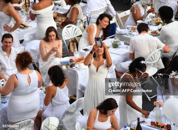 Guests attend the annual New York City Diner en Blanc, August 22 held this year at the plaza at Lincoln Center. The Diner en Blanc, the worlds only...