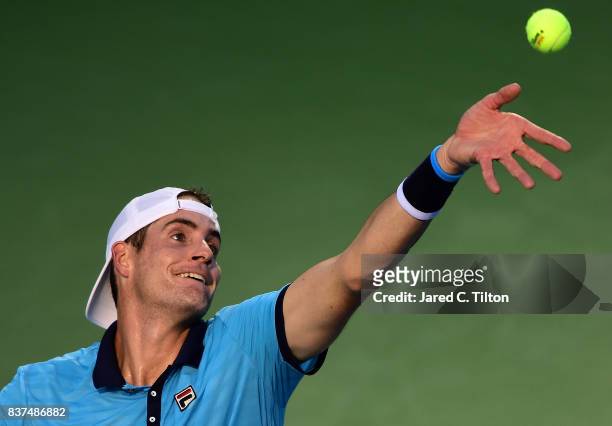 John Isner serves to Andrey Kuznetsov of Russia during the fourth day of the Winston-Salem Open at Wake Forest University on August 22, 2017 in...