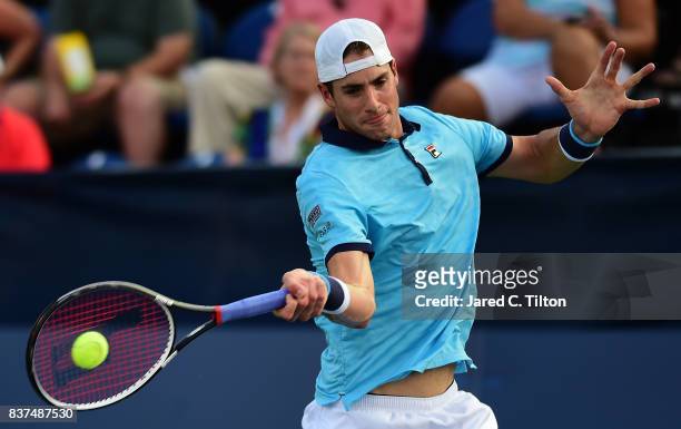 John Isner returns a shot from Andrey Kuznetsov of Russia during the fourth day of the Winston-Salem Open at Wake Forest University on August 22,...