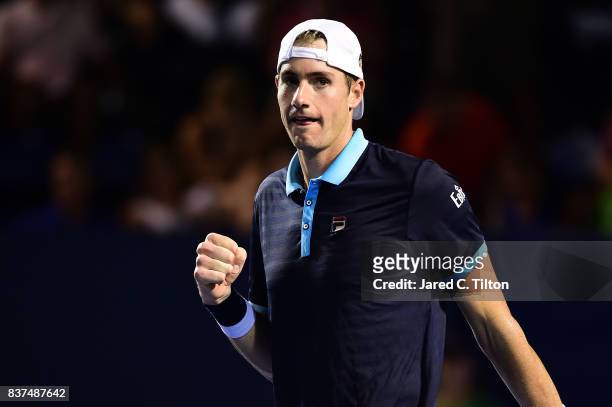 John Isner reacts after winning his match against Andrey Kuznetsov of Russia during the fourth day of the Winston-Salem Open at Wake Forest...