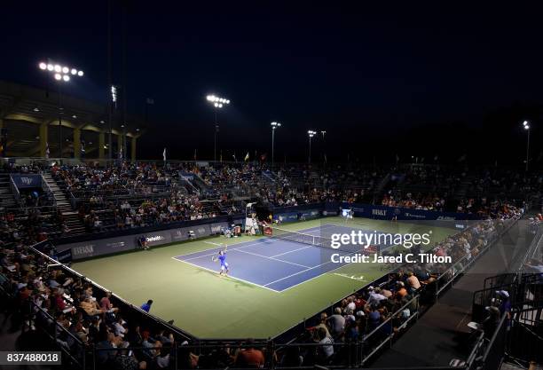 Andrey Kuznetsov of Russia serves to John Isner during the fourth day of the Winston-Salem Open at Wake Forest University on August 22, 2017 in...