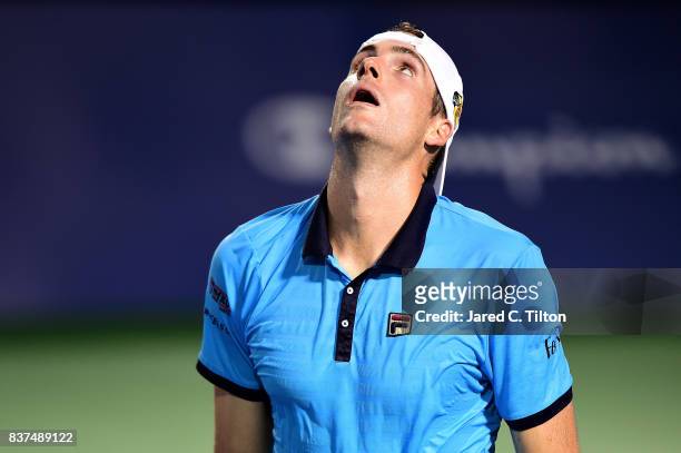 John Isner reacts after a point against Andrey Kuznetsov of Russia during the fourth day of the Winston-Salem Open at Wake Forest University on...
