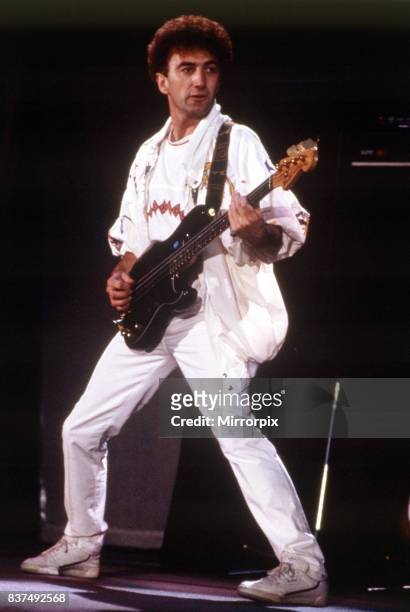 Queen Rock Group John Deacon playing bass guitar Queen in concert at Wembley Stadium.