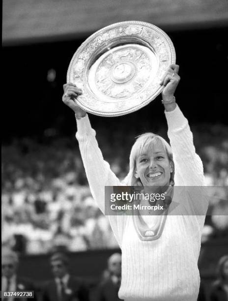 Martina Navratilova beat Chris Evert and won the Wimbledon ladies singles final and hold up the trophy.