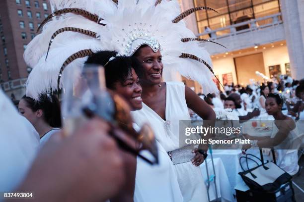 Diners participate in the annual "Diner en Blanc" at Lincoln Center on August 22, 2017 in New York City. Diner en Blanc began in France nearly 30...