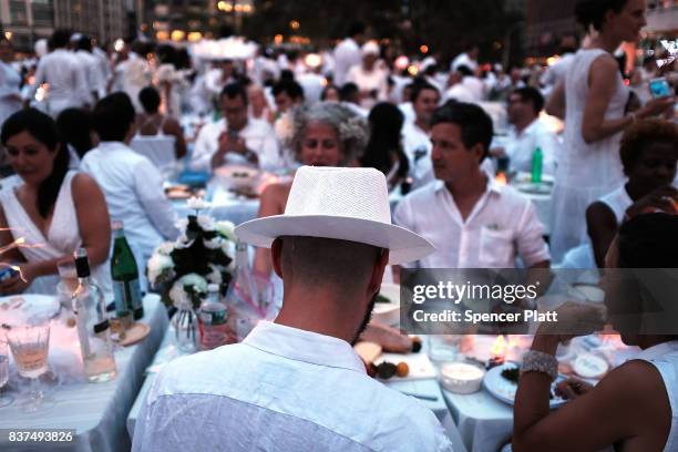 People enjoy dinner at the annual "Diner en Blanc" at Lincoln Center on August 22, 2017 in New York City. Diner en Blanc began in France nearly 30...