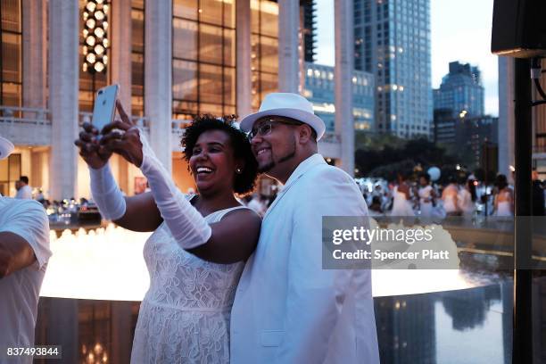 Diners participate in the annual "Diner en Blanc" at Lincoln Center on August 22, 2017 in New York City. Diner en Blanc began in France nearly 30...