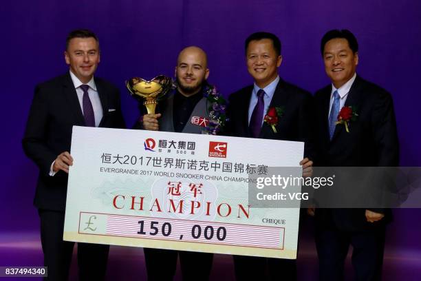 Luca Brecel of Belgium celebrates with his trophy after the final match against Shaun Murphy of England on day seven of Evergrande 2017 World Snooker...