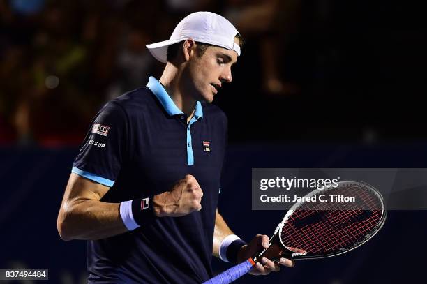 John Isner reacts after a point against Andrey Kuznetsov of Russia during the fourth day of the Winston-Salem Open at Wake Forest University on...