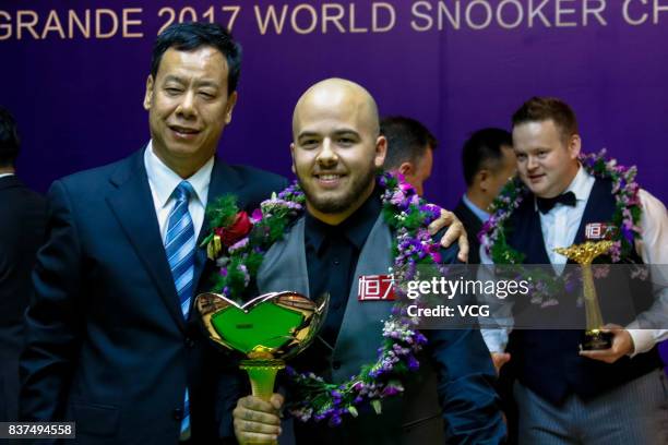 Luca Brecel of Belgium celebrates with his trophy after the final match against Shaun Murphy of England on day seven of Evergrande 2017 World Snooker...