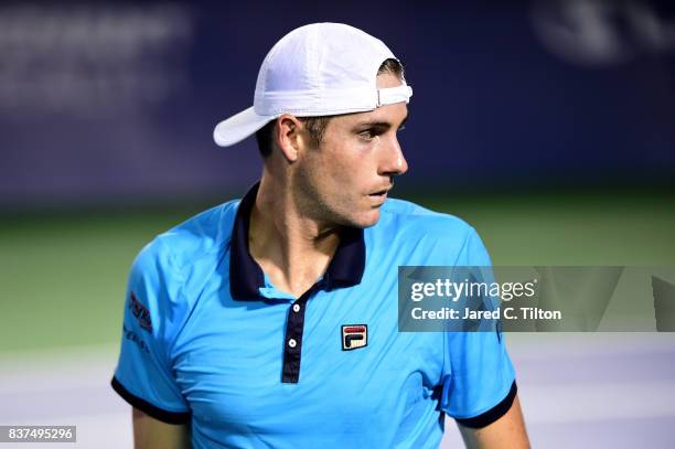 John Isner looks on during his match against Andrey Kuznetsov of Russia during the fourth day of the Winston-Salem Open at Wake Forest University on...