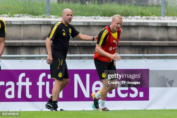 Head coach Peter Bosz of Dortmund and Sebastian Rode of Dortmund looks on during a training session as part of the training camp on July 31, 2017 in...