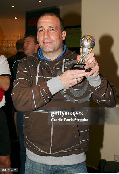 Representative of the english national fan team celebrates the participation by showing his trophy from the fan club rematch of wembley 2007 at the...