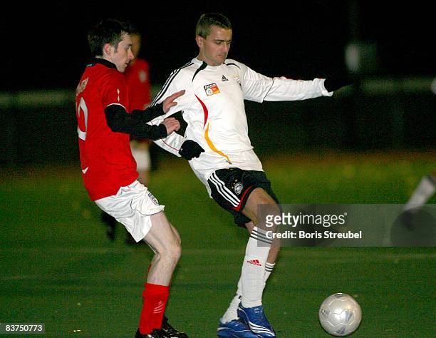 Player of the german national fan team battles for the ball with a player of the english national fan team during to the fan club rematch of wembley...