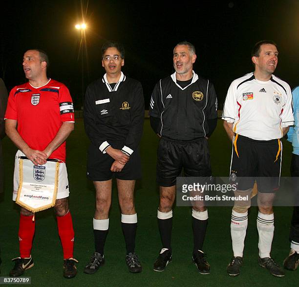 The teamster of the german national fan team , the teamster of the english national fan team and the referees are seen in advance to the fan club...