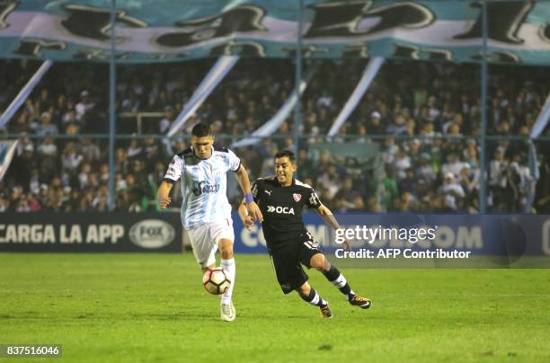 David Barbona of Atletico Tucuman disputes the ball with Diego Rodriguez of Independiente in their Copa Sudamericana 2017 match in the Jose Fierro...
