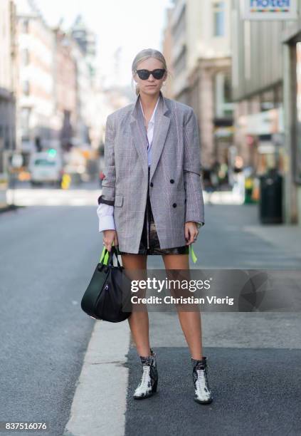 Tine Andrea wearing a grey blazer, black Loewe bag, black mini skirt outside Moods of Norway on August 22, 2017 in Oslo, Norway.