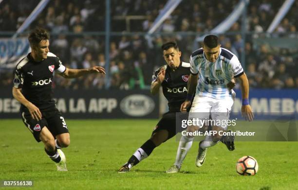 David Barbona of Atletico Tucuman vies for the ball with Diego Rodriguez of Independiente during their Copa Sudamericana 2017 football match at the...
