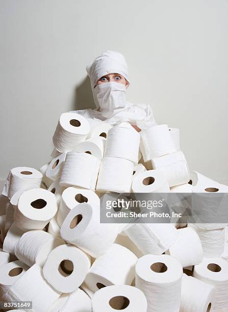 woman neck-deep in toiletpaper - wrapped in toilet paper stock-fotos und bilder