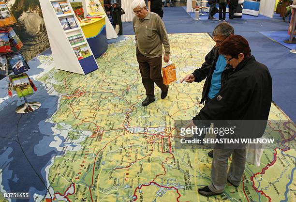 Visitors walk on a carpet featuring the mab of German state of Mecklenburg-Vorpommern on November 19, 2008 at the International Tourism and...