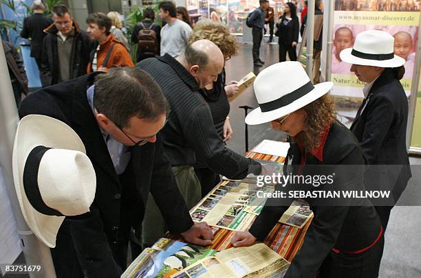 Visitors listen to tourism experts wearing Panama hats on November 19, 2008 at the International Tourism and Caravaning fair in Leipzig, eastern...