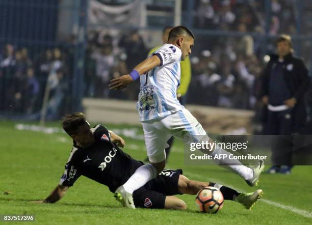 David Barbona of Atletico Tucuman disputes the ball with Nicolas Tagliafico of Independiente in their Copa Sudamericana match at the Jose Fierro...