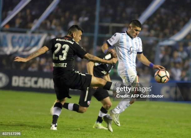 David Barbona of Atletico Tucuman disputes the ball with Nery Dominguez of Independiente in their Copa Sudamericana 2017 match in the Jose Fierro...