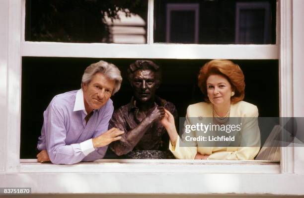 British photographer Lord Lichfield, beside a bust of himself, with his sister Lady Elizabeth Anson photographed at her home in West London on 18th...