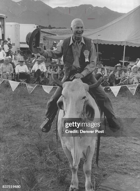 Charles C. Gates, a 3R Director President of the Gates Corporation enjoys his ride on a trained Brahma Bull which was owned and trained by George...